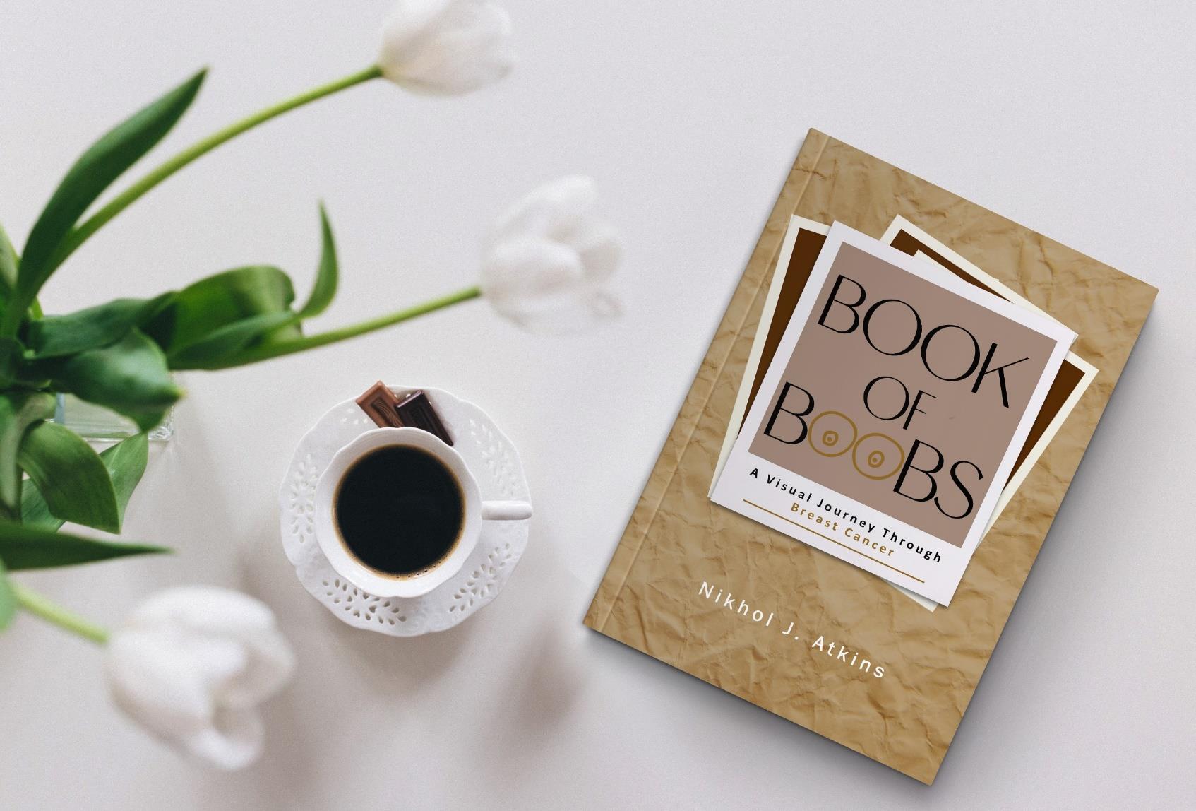 Book of Boobs: A Visual Journey Through Breast Cancer by Nikhol J. Atkins, beside a cup of coffee